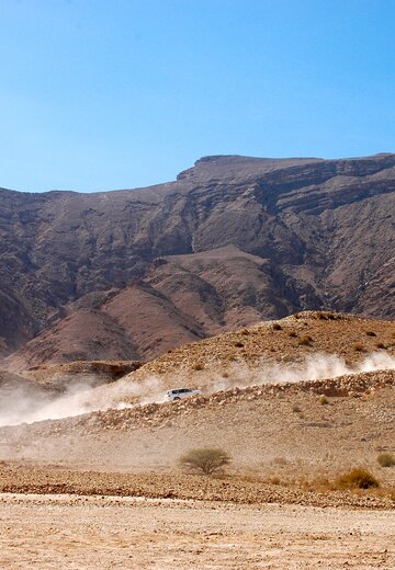 In einer aufgewirbelten Sandwolke sind kaum noch Fahrzeuge zu erkennen. Das gehört zum Offroadfahren in Oman. Offroad Oman.  | © 4x4 Exploring GmbH